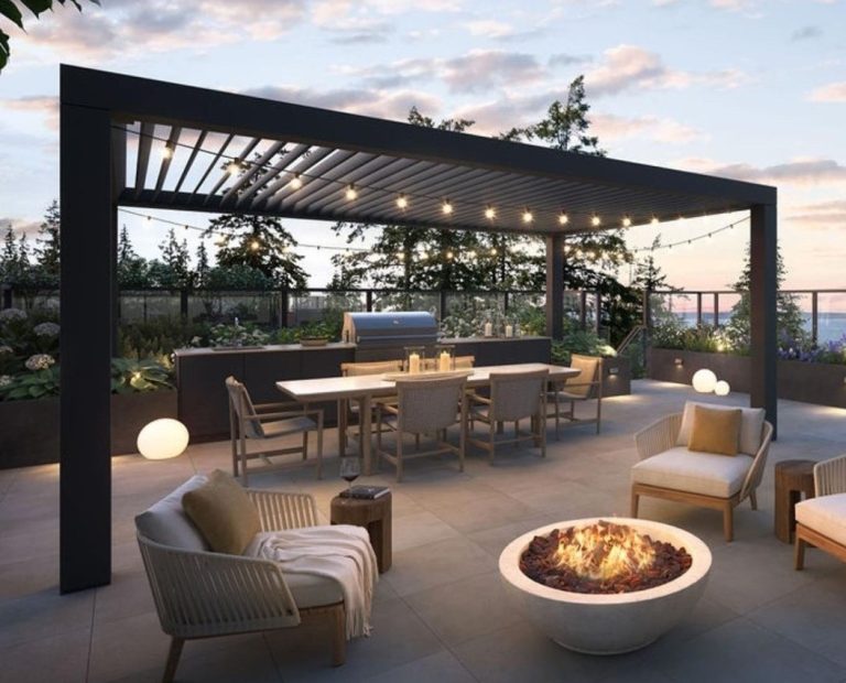 Modern outdoor patio with a pergola, dining table, chairs, grill, fire pit, and string lights at sunset.