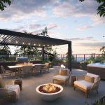 Rooftop terrace with seating, fire pit, hot tub, pergola, and string lights at sunset.